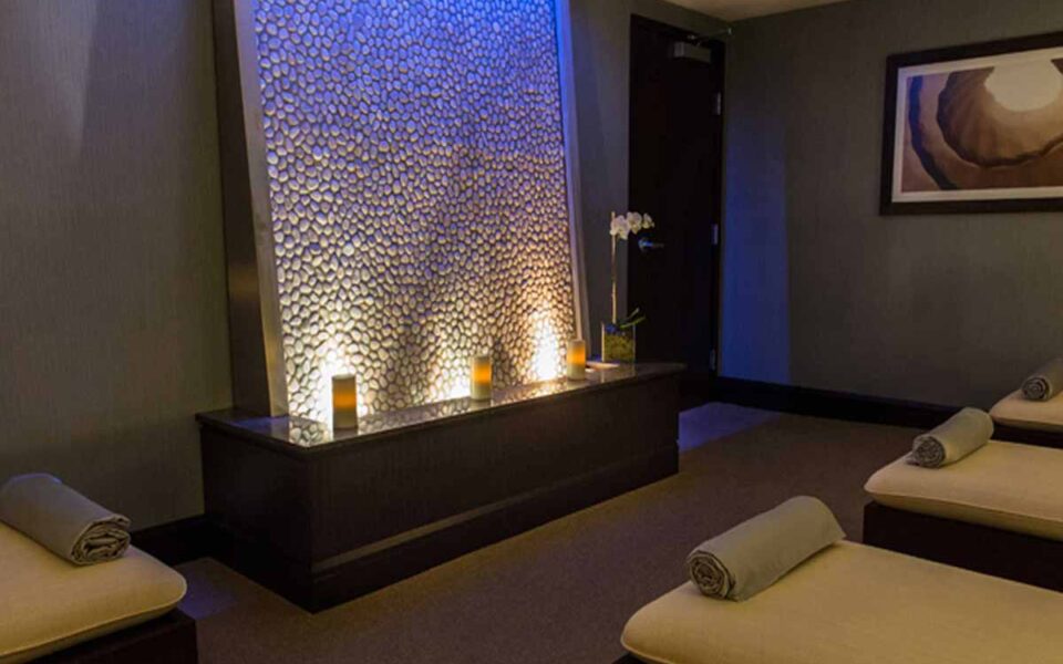 inside a massage room with a relaxing waterfall in dim room