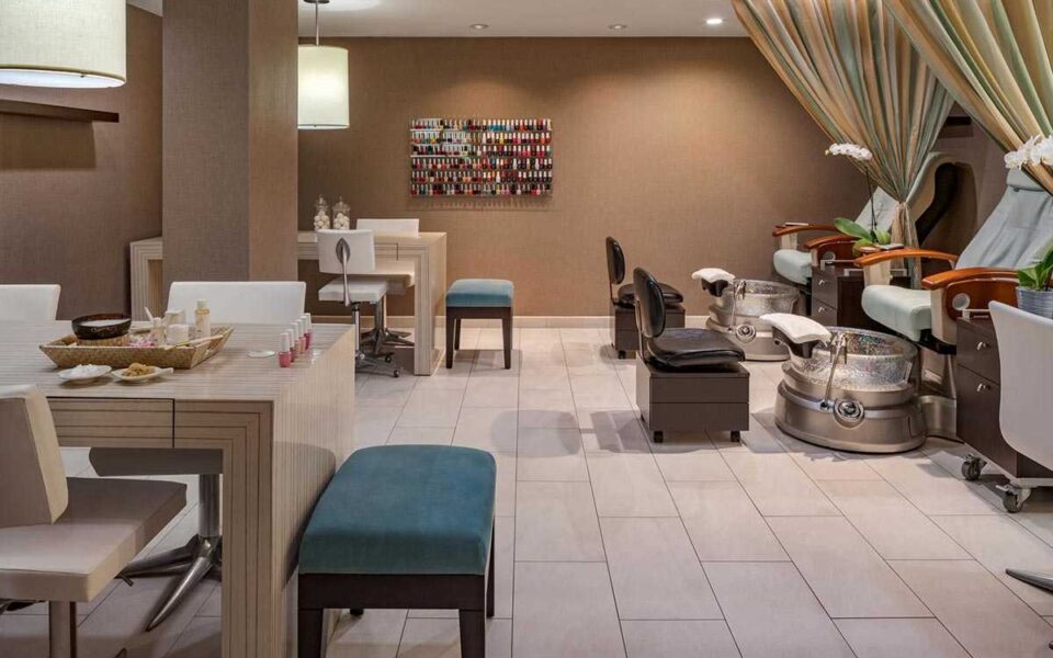 a luxury beach spa salon room with stations for manicures, pedicures, and other salon treatments