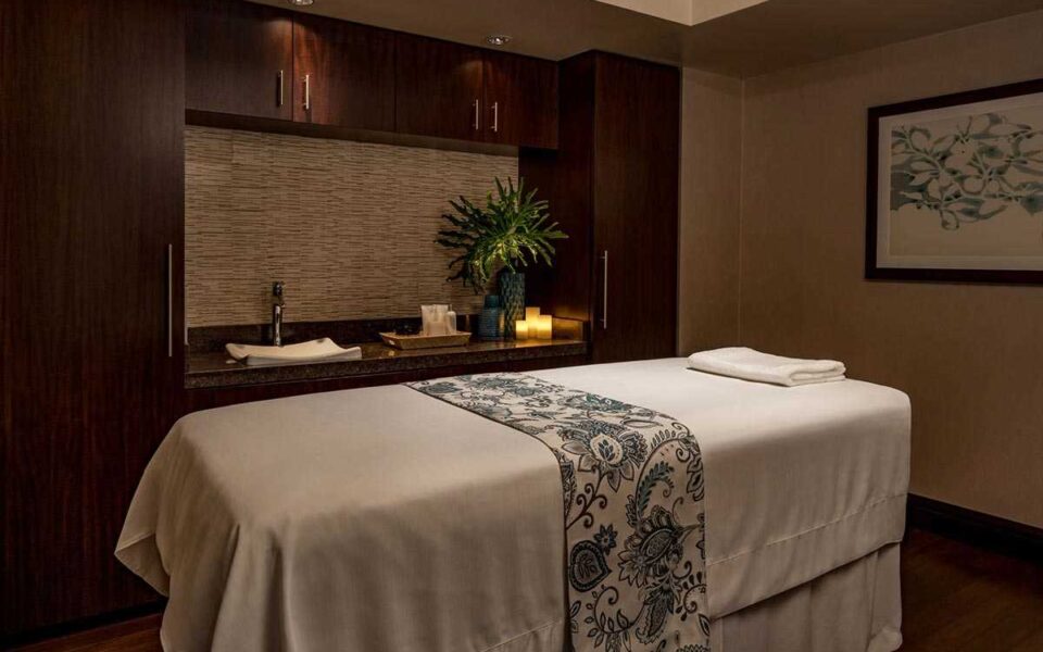 a spa massage bed in a room with the lights dimmed