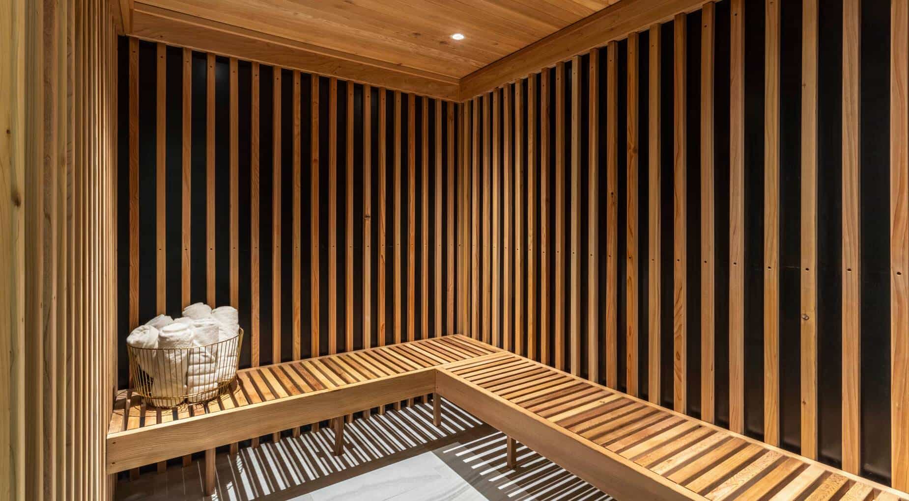 a wooden sauna with benches and a towel holder